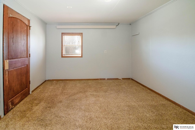 carpeted spare room with crown molding