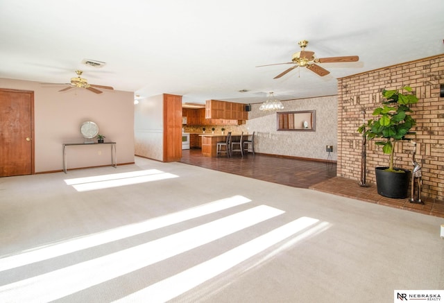 unfurnished living room featuring dark carpet and ceiling fan