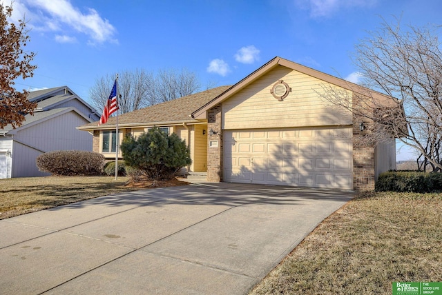 ranch-style home featuring a garage and a front lawn