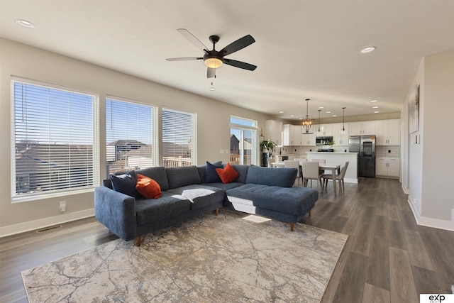 living room with ceiling fan and wood-type flooring