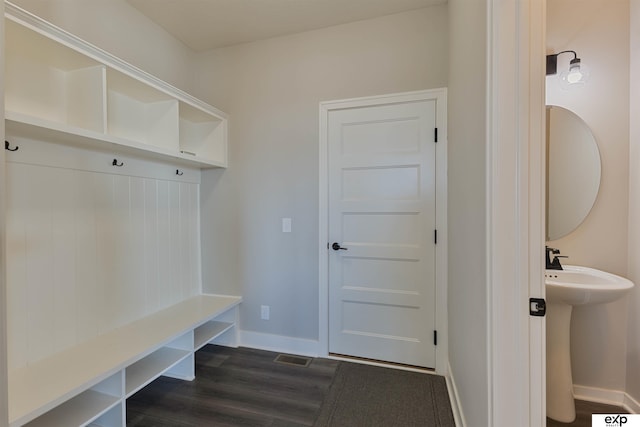 mudroom with sink and dark hardwood / wood-style floors