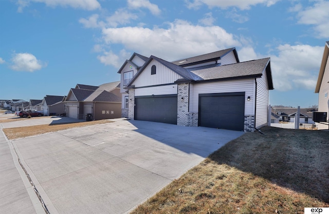 view of front of home featuring a garage, central AC, and a front yard