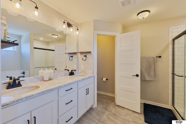 bathroom with vanity and a shower with shower door