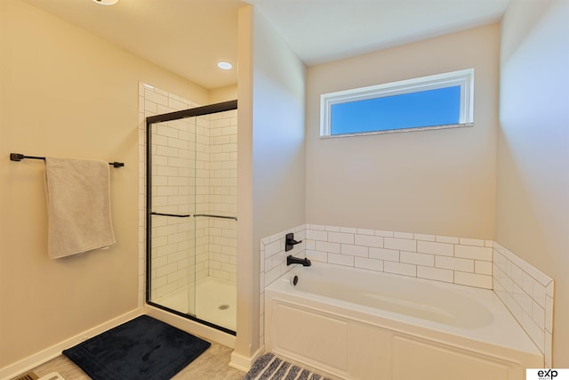 bathroom featuring shower with separate bathtub