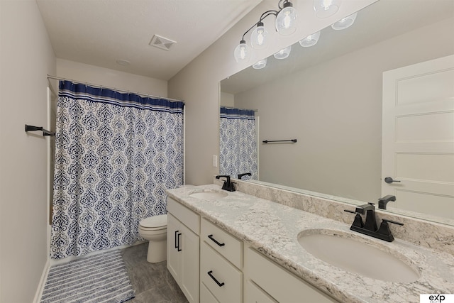 bathroom with walk in shower, vanity, and toilet