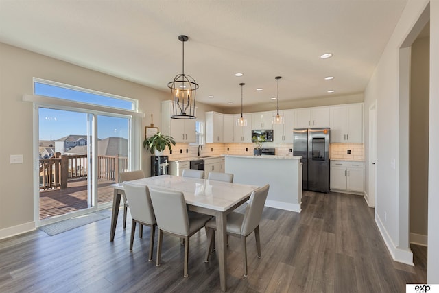 dining room with dark hardwood / wood-style flooring and sink