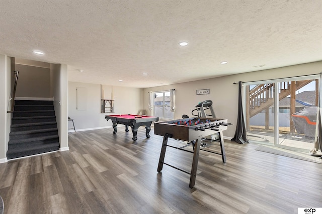 recreation room with hardwood / wood-style floors, pool table, and a textured ceiling