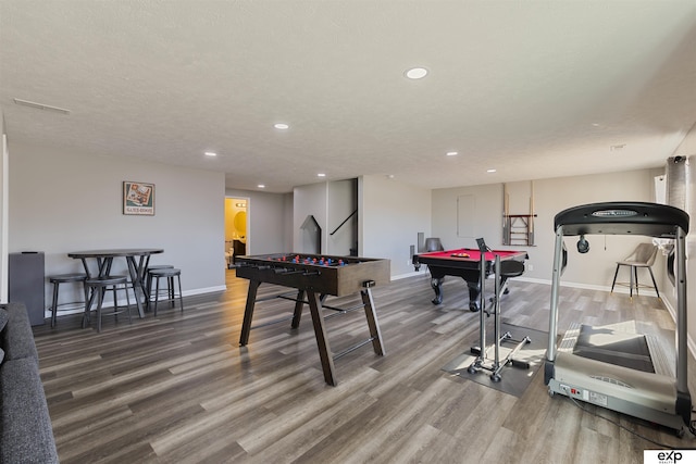 recreation room with billiards, wood-type flooring, and a textured ceiling