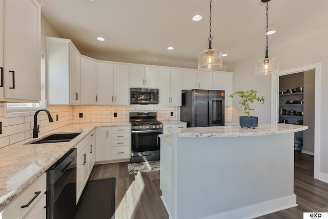 kitchen with white cabinetry, pendant lighting, a kitchen island, and appliances with stainless steel finishes