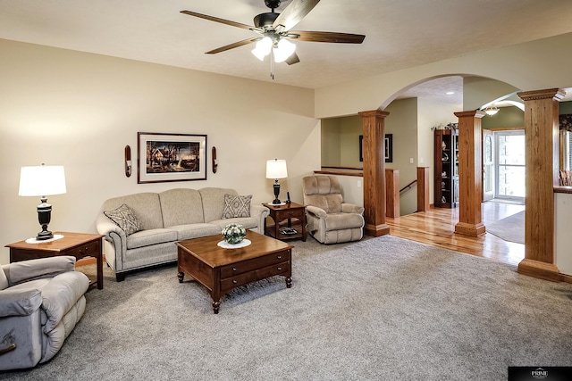 living room with ceiling fan, carpet flooring, and ornate columns