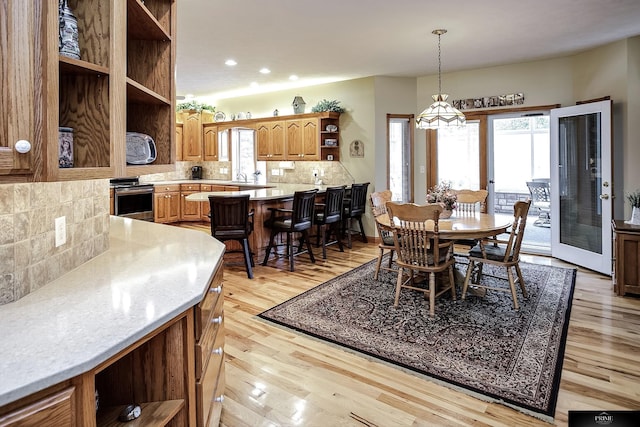 dining space featuring sink and light hardwood / wood-style floors