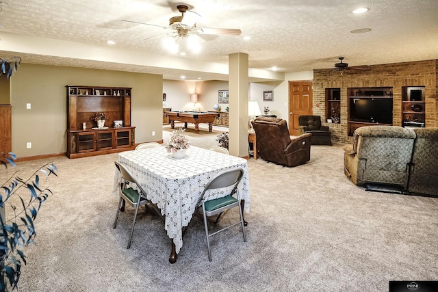 carpeted dining area with pool table, a textured ceiling, and ceiling fan