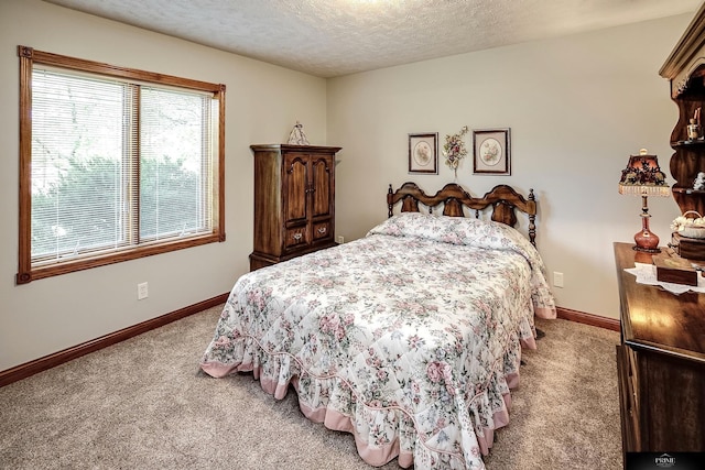 bedroom with a textured ceiling and carpet floors