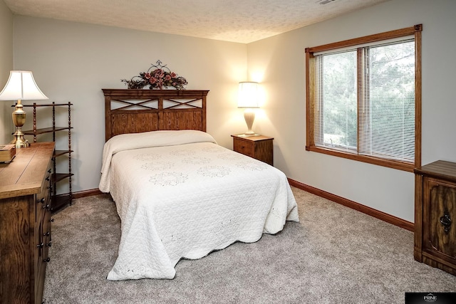 carpeted bedroom featuring a textured ceiling