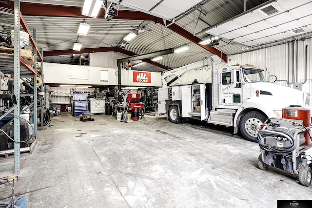 garage featuring a garage door opener and a workshop area