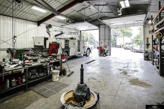 garage featuring a garage door opener and a workshop area