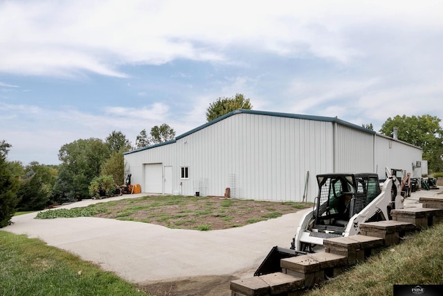 exterior space featuring an outbuilding and a garage