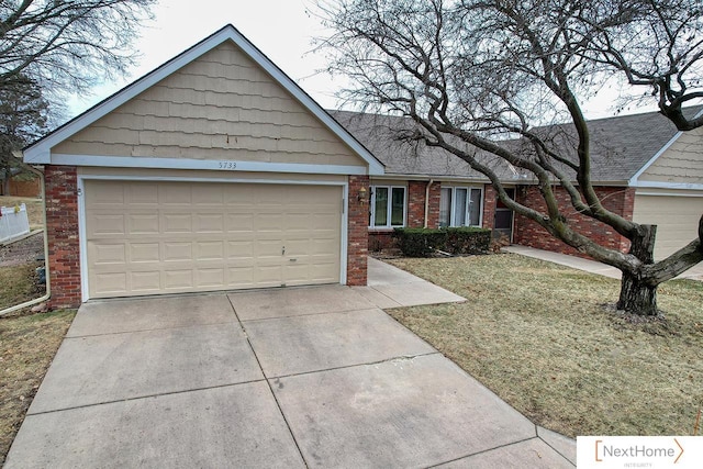 ranch-style house featuring a garage and a front yard