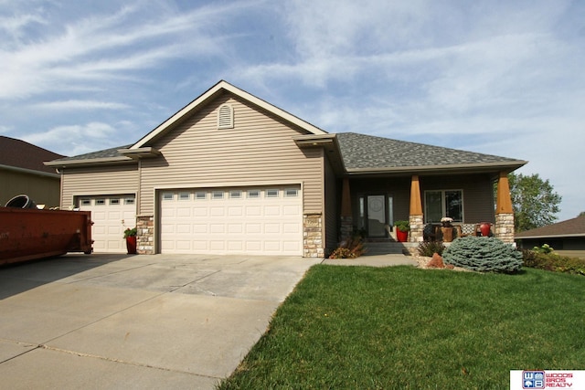 view of front of house featuring a garage, covered porch, and a front yard