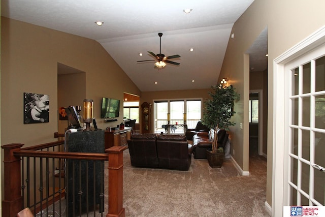 living room with ceiling fan, lofted ceiling, and carpet flooring