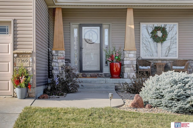 entrance to property featuring a porch