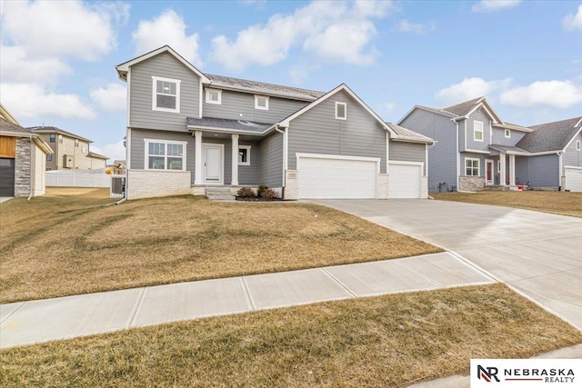 view of front of house featuring a garage and a front lawn