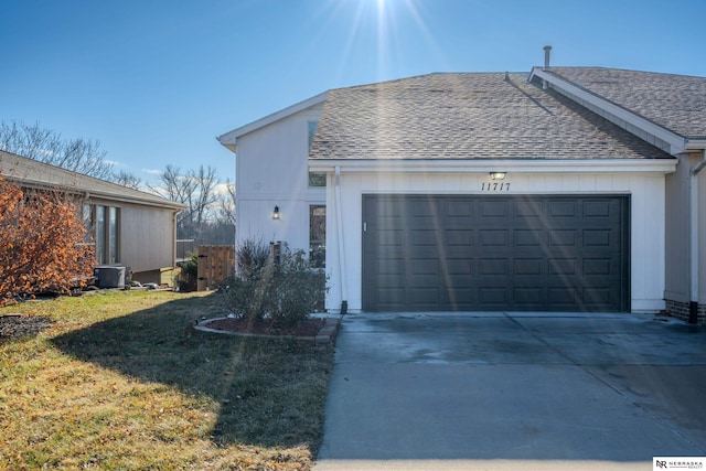 view of home's exterior featuring central AC unit, a yard, and a garage