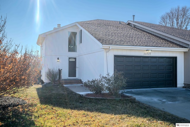 ranch-style home featuring a garage and a front lawn