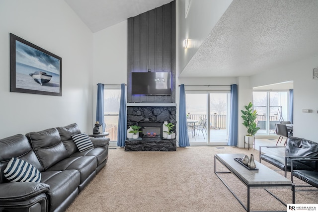 living room featuring a fireplace, carpet flooring, and a textured ceiling