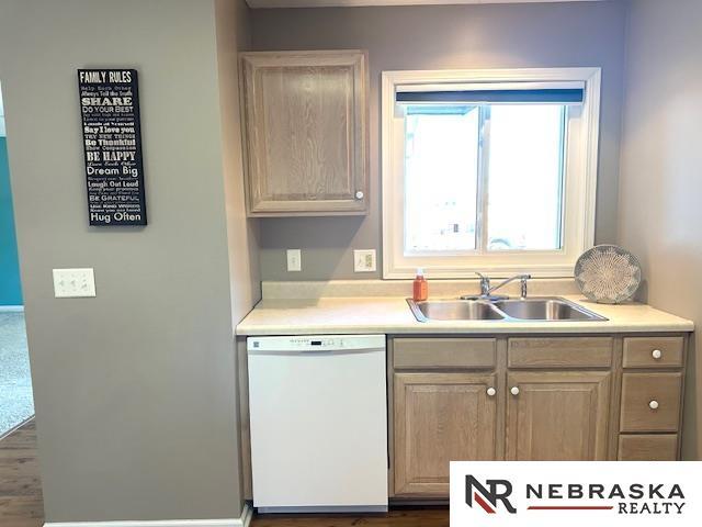 kitchen featuring sink, light brown cabinets, and dishwasher