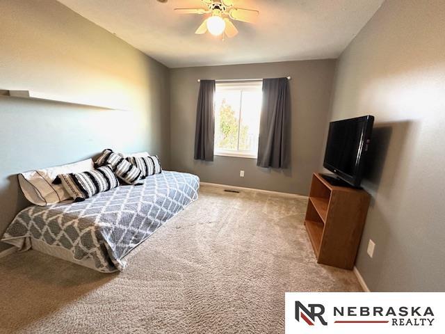 bedroom with ceiling fan and carpet floors