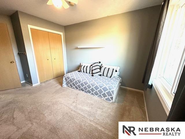 bedroom featuring a closet, ceiling fan, and carpet flooring