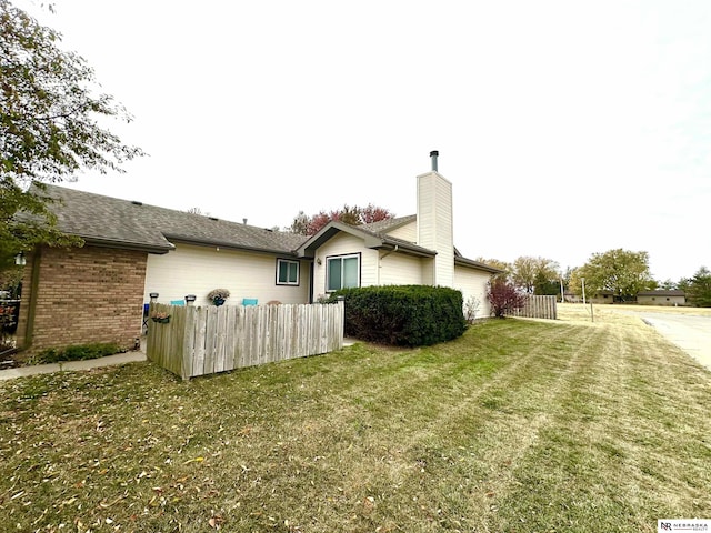 view of side of home featuring a lawn