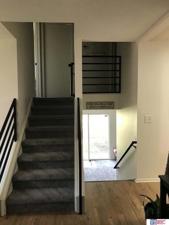 stairway featuring hardwood / wood-style flooring