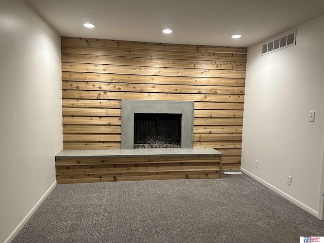 interior details with carpet and wooden walls