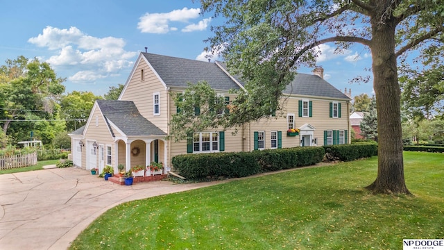 view of front facade with a garage and a front lawn