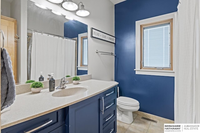 bathroom with toilet, tile patterned floors, and vanity