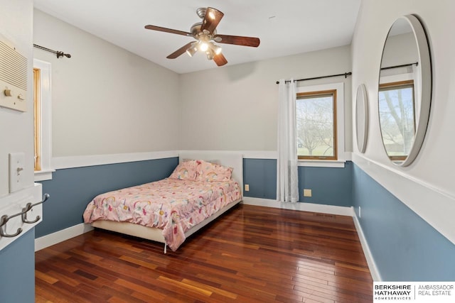 bedroom featuring ceiling fan and dark wood-type flooring