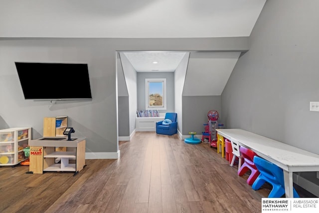 game room with hardwood / wood-style floors and vaulted ceiling