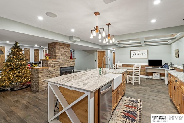 kitchen with dishwasher, a spacious island, dark hardwood / wood-style flooring, decorative light fixtures, and sink