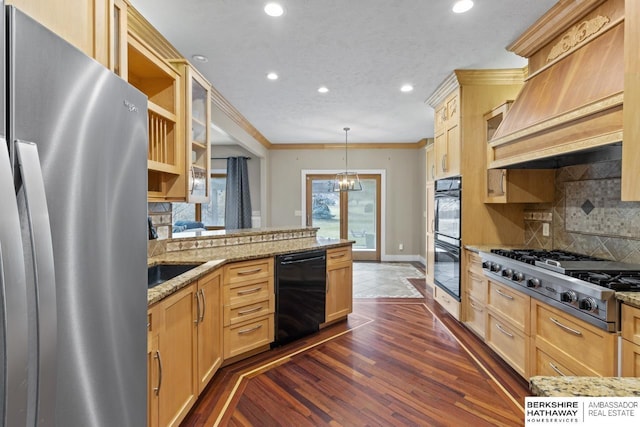 kitchen with black appliances, custom range hood, decorative backsplash, decorative light fixtures, and light brown cabinets