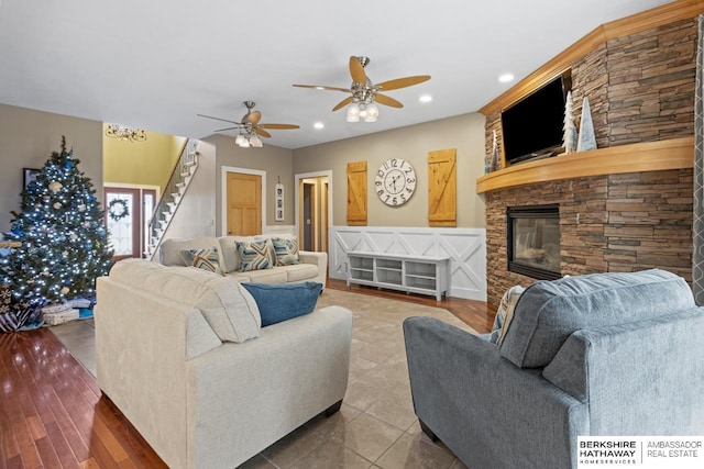 tiled living room featuring a stone fireplace