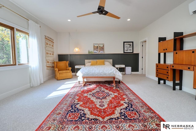 carpeted bedroom featuring a wall mounted air conditioner and ceiling fan