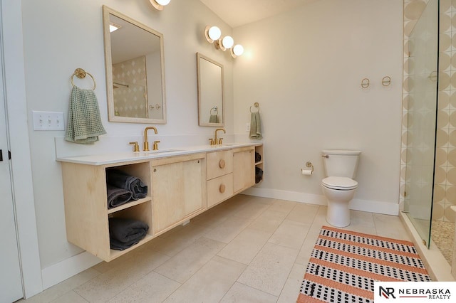 bathroom featuring tile patterned floors, a shower with door, toilet, and vanity