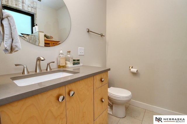 bathroom with toilet, tile patterned flooring, and vanity