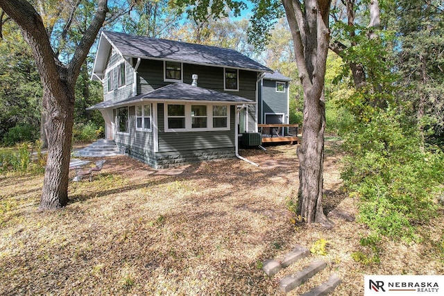 view of front of home with a wooden deck and central AC unit