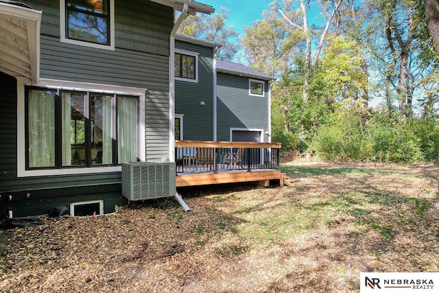 back of property featuring central air condition unit and a deck