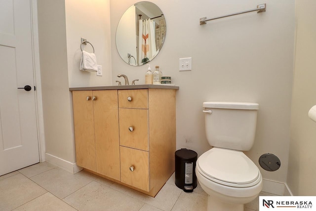 bathroom featuring vanity, toilet, and tile patterned floors