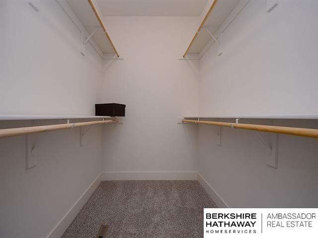 walk in closet featuring carpet flooring