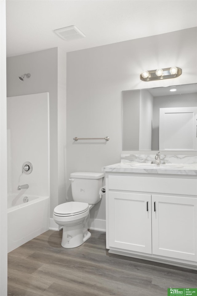 full bathroom with vanity, toilet, shower / washtub combination, and wood-type flooring